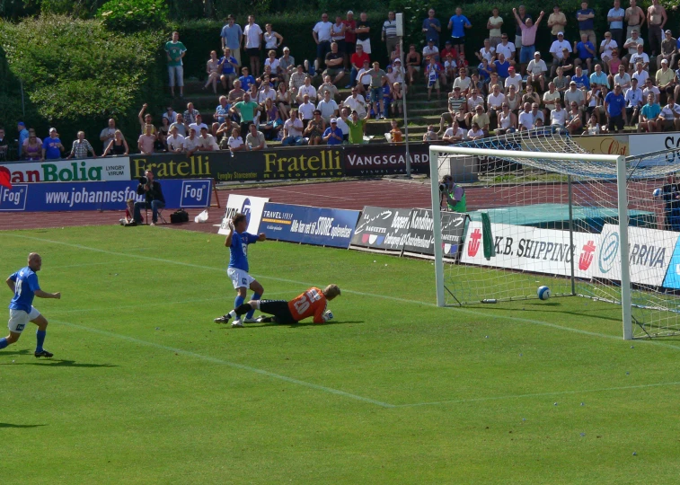 some people are playing a soccer game on a grass field