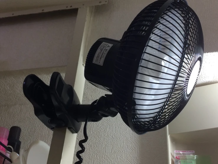 a closeup of a black fan and it's cord