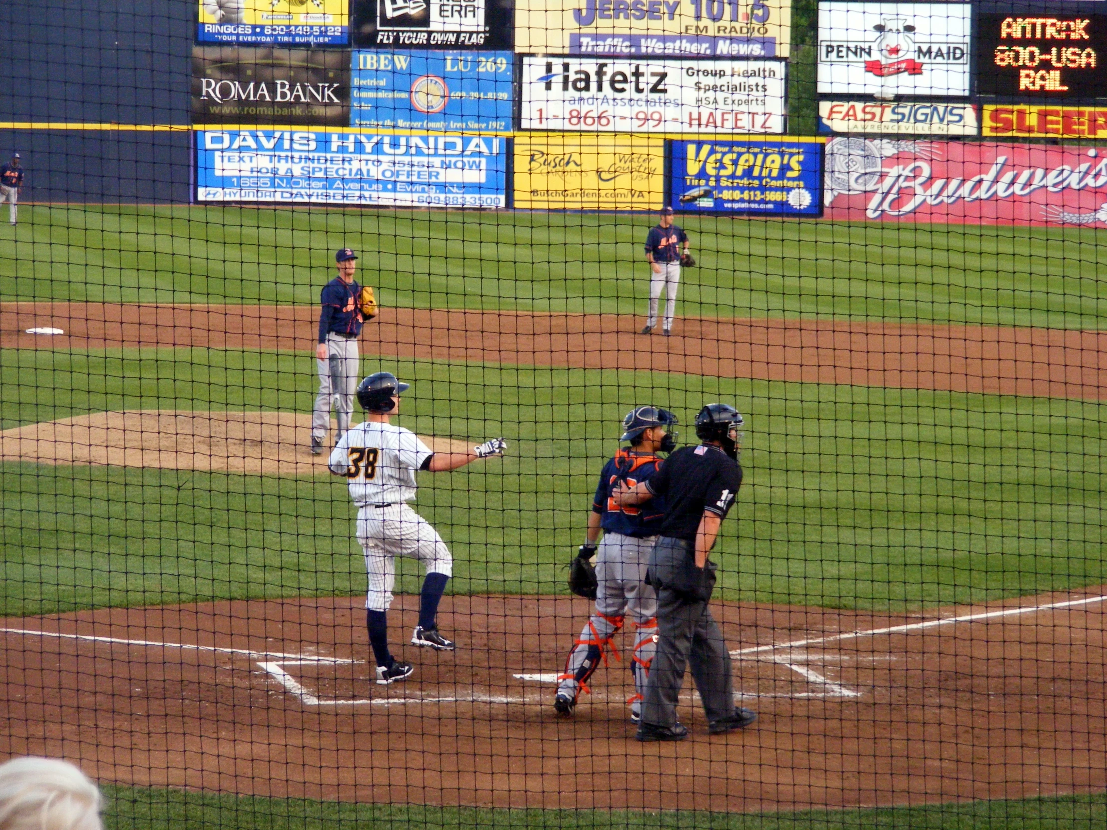 a baseball game is in progress with a batter at the plate