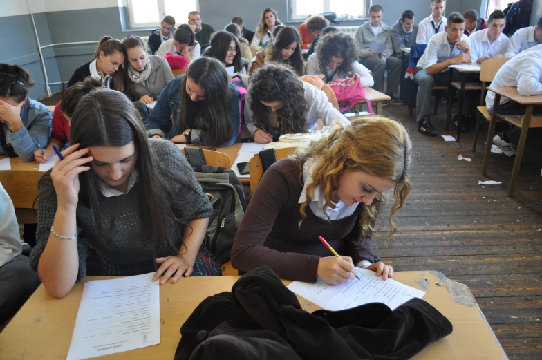 a group of people sitting in a classroom