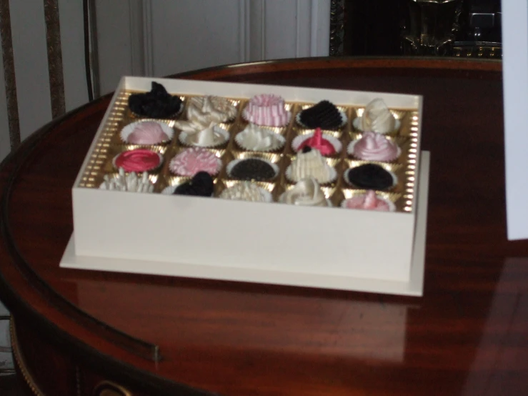 a tray full of some assorted pastries on a table