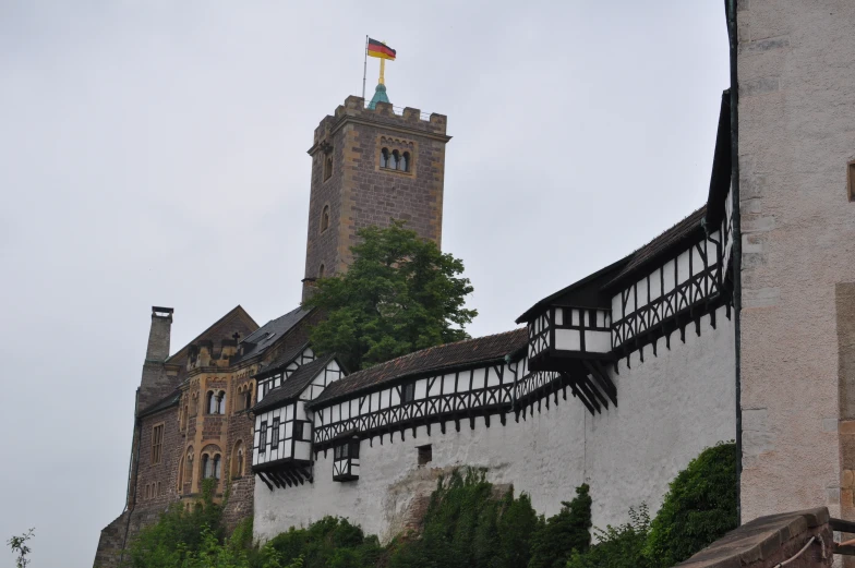 a castle with two flags sticking out of the roof