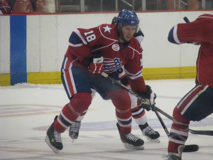 two people playing in a hockey game one man is in action