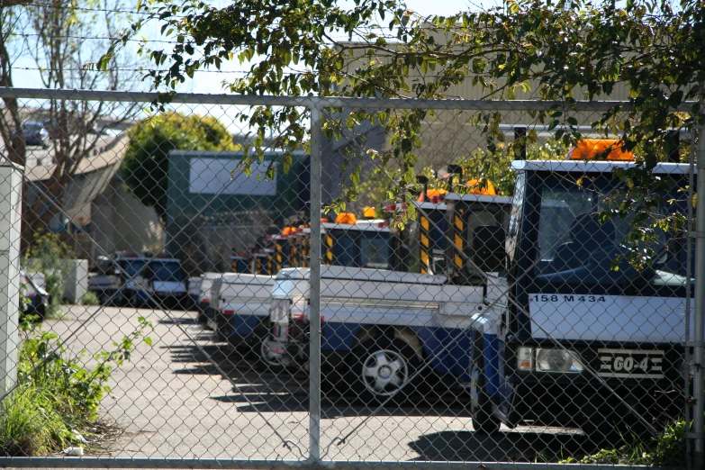 a number of truck behind a fence and a fence