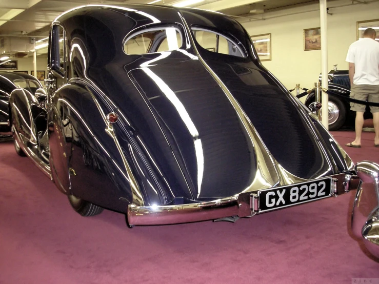 an antique car is shown on display inside