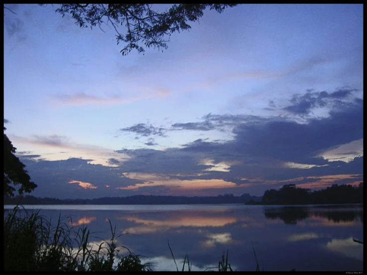 a large body of water under a cloudy sky