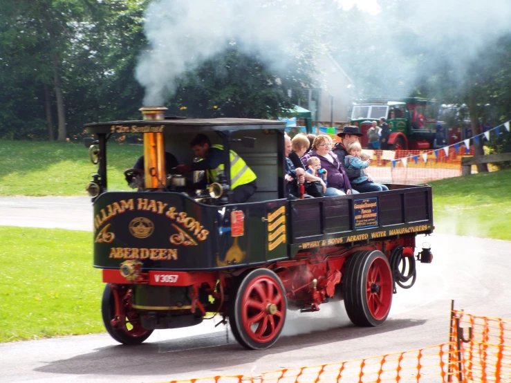 small train being ridden in a park setting