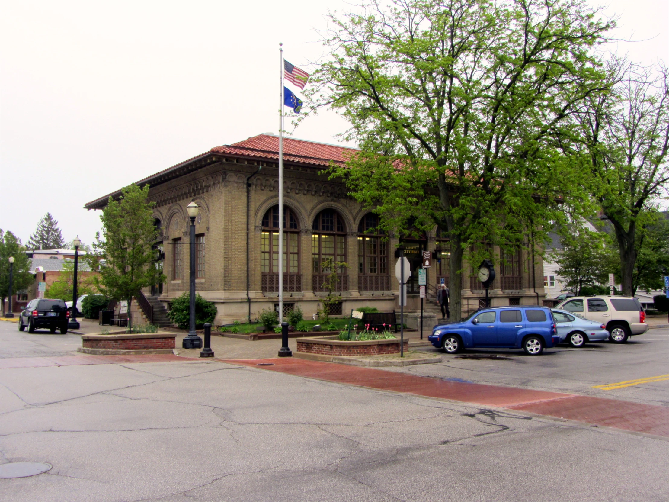 the blue car is parked in front of the building