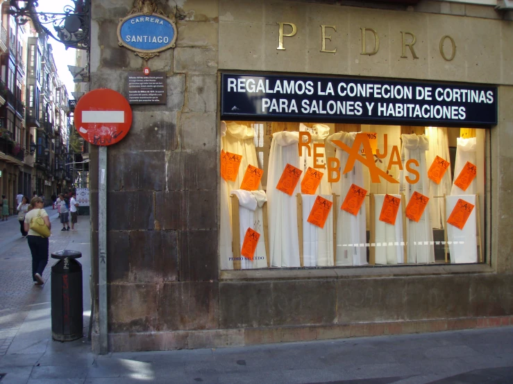 the front of a building is decorated with signs and clothes