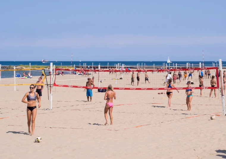 the beach volleyball players are ready to play