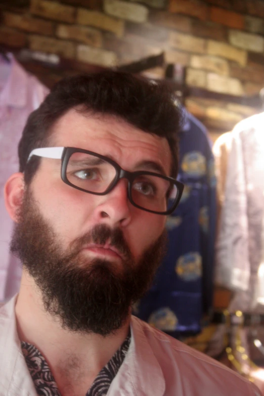 there is a man with a beard and glasses making an expression