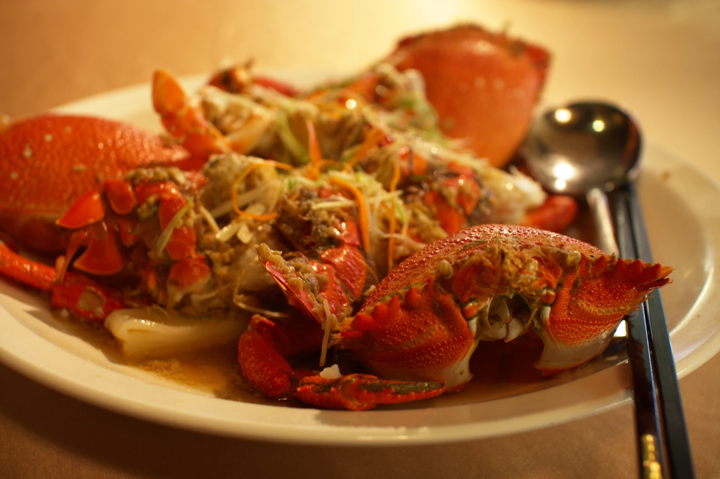 a plate of lobster and vegetables with two forks