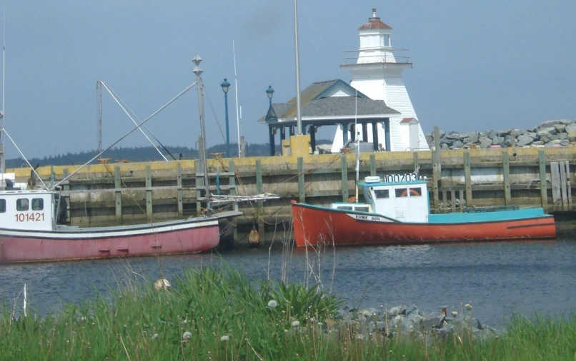 two red boats in a small body of water