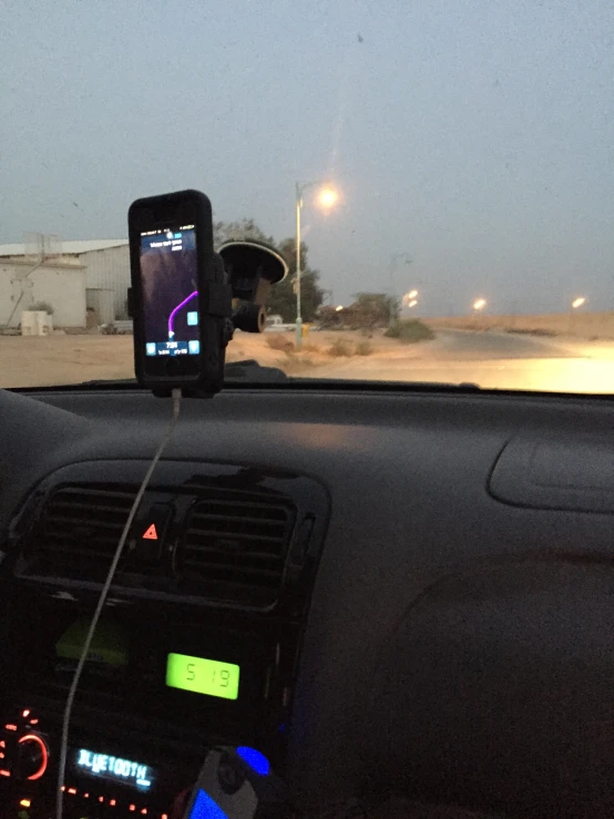 a cell phone is attached to a dashboard of a vehicle