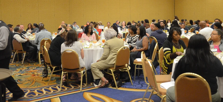 people are sitting around tables during a celetion