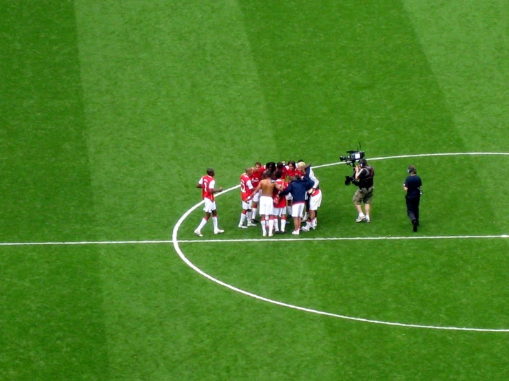 a team huddled on a soccer field