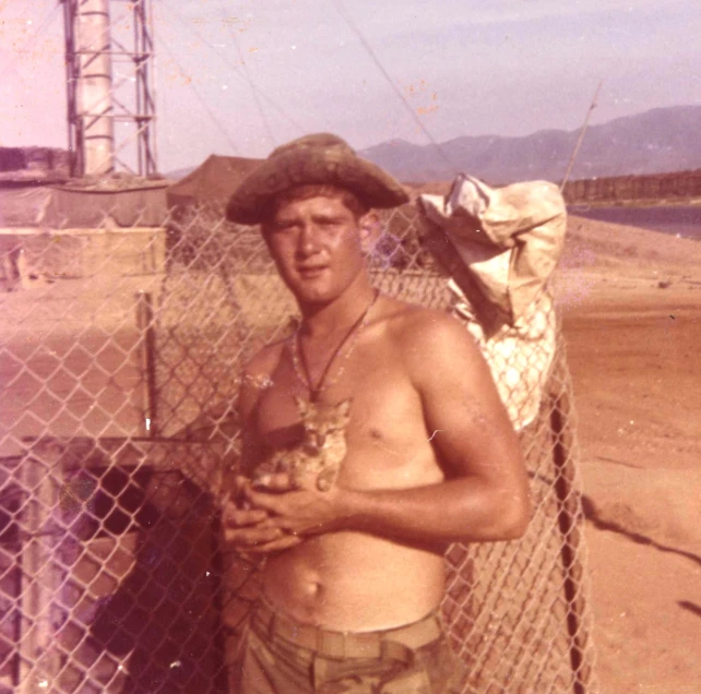 there is a man with  standing in front of a fence