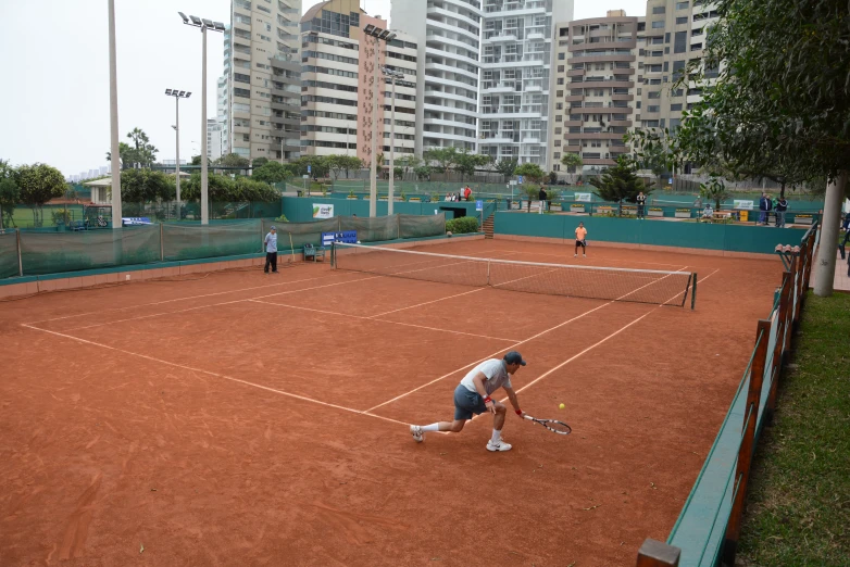 two women standing on a tennis court holding racquets