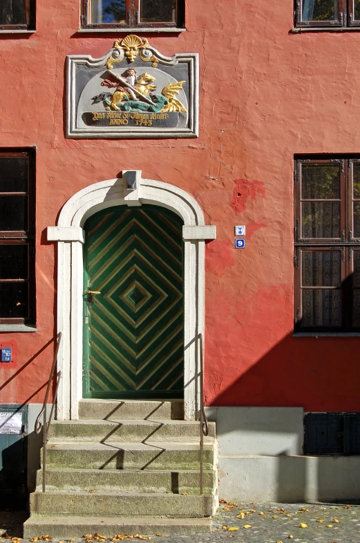 a green door sits on top of steps