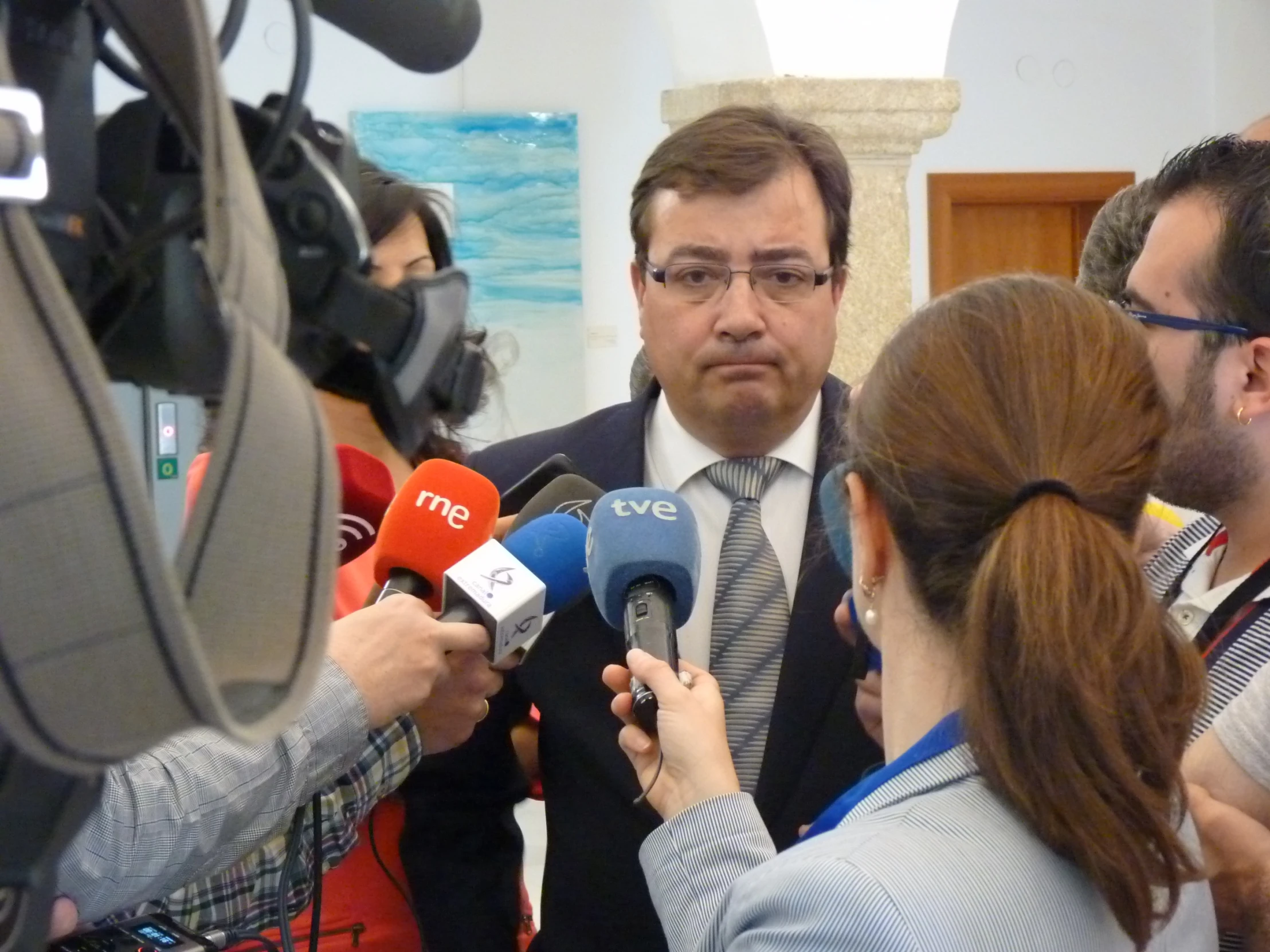 a man talking to reporters at an event