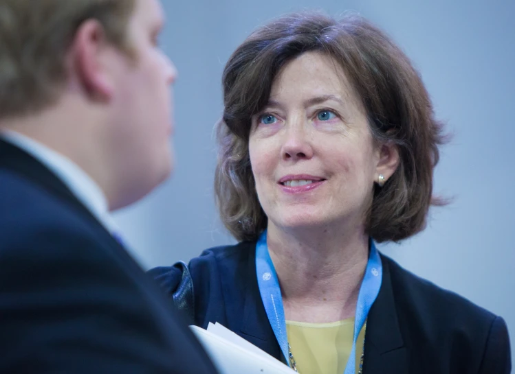 a woman talking to another person during a business meeting