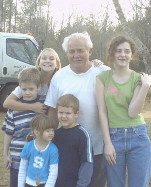 a man with two children and an adult posing for a po