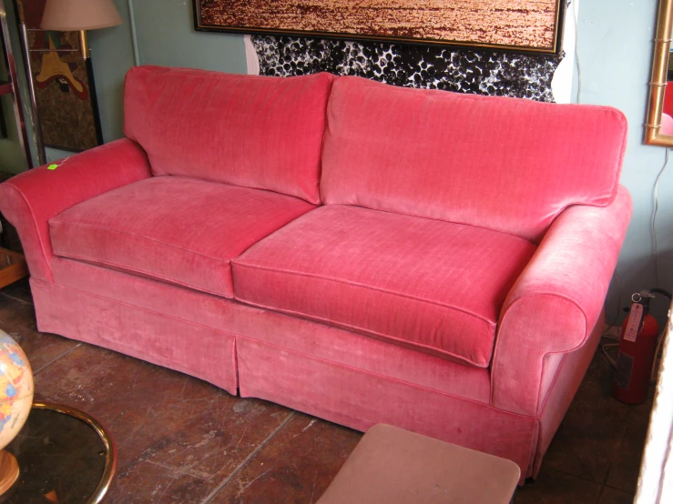 red sofa with three back cushions in room