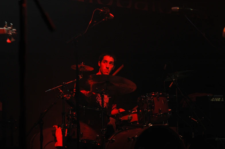 a drummer playing on the drums at night