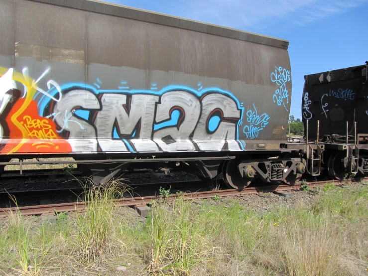 a painting that looks like graffiti is on the side of a train