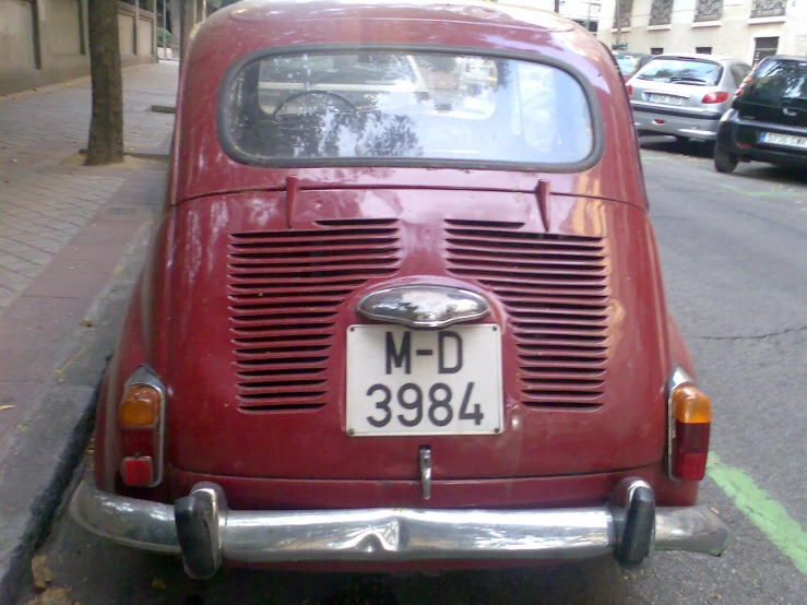 a red car parked on the side of a street