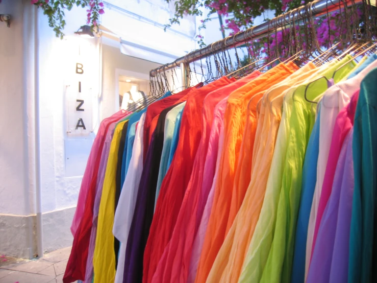 colorful shirts hanging on racks in a store