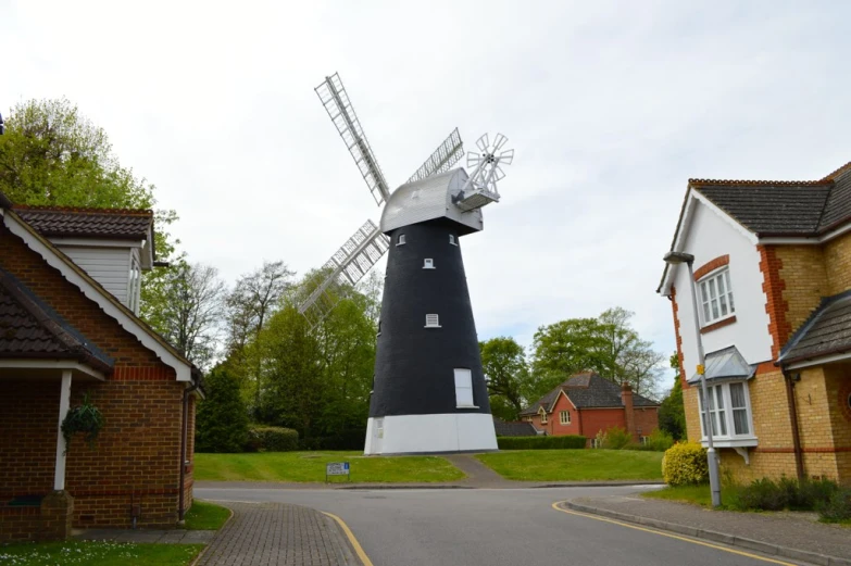 a windmill sitting in the middle of a road