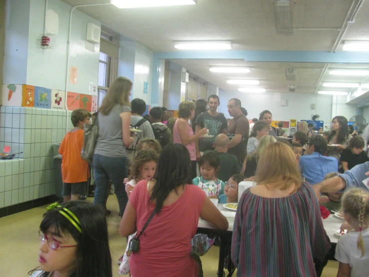 a crowded room full of children and adults