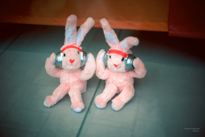 two stuffed bunny rabbits listening to music