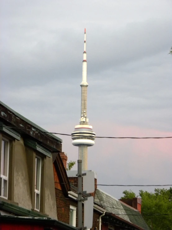 the tall tower stands in the middle of buildings