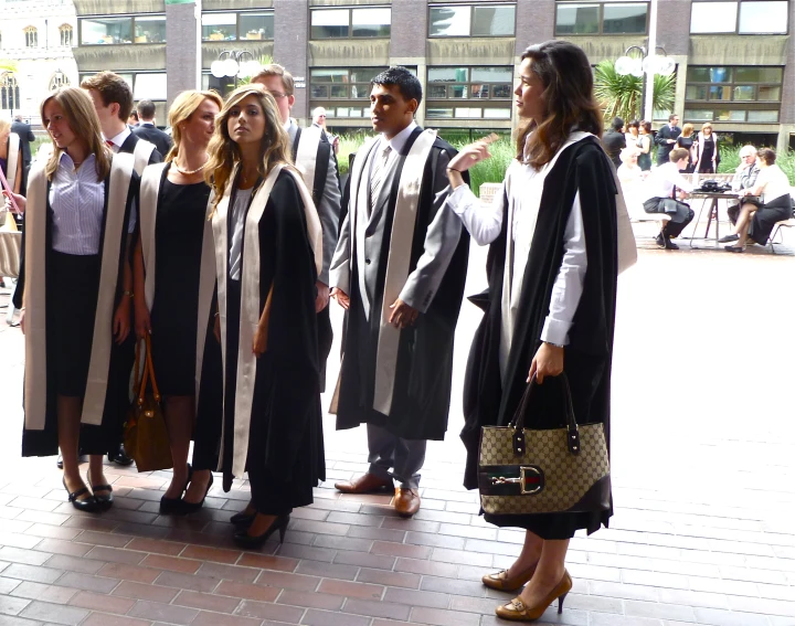 students in graduation robes and holding their graduation cap and gown