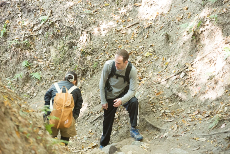 two people are walking up a steep incline