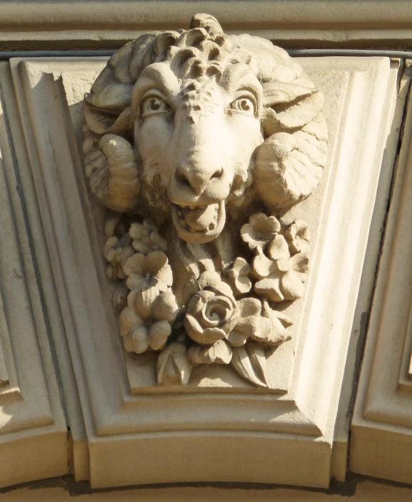 the face of a lion carved into a building