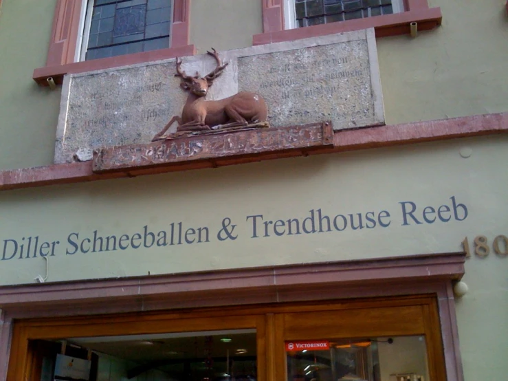 a sculpture of a deer on a store front
