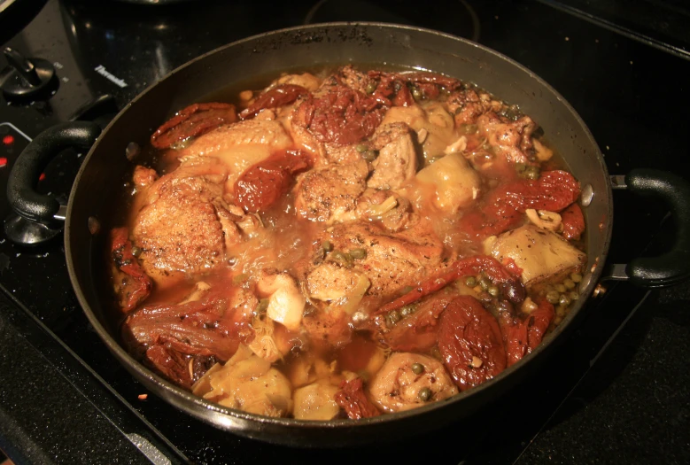 the meat and potatoes are simmering in the wok