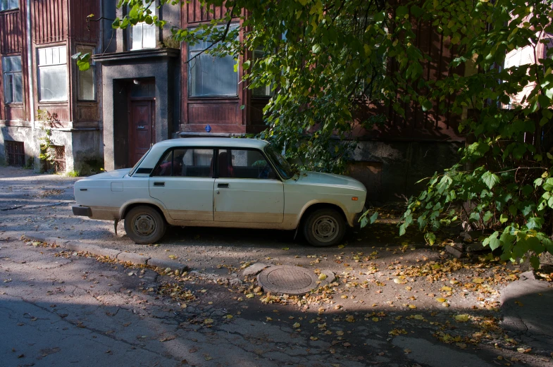 a car parked in front of a building on a street corner