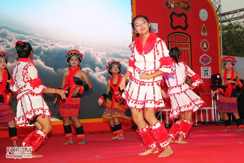 several dancers in traditional attire standing on stage