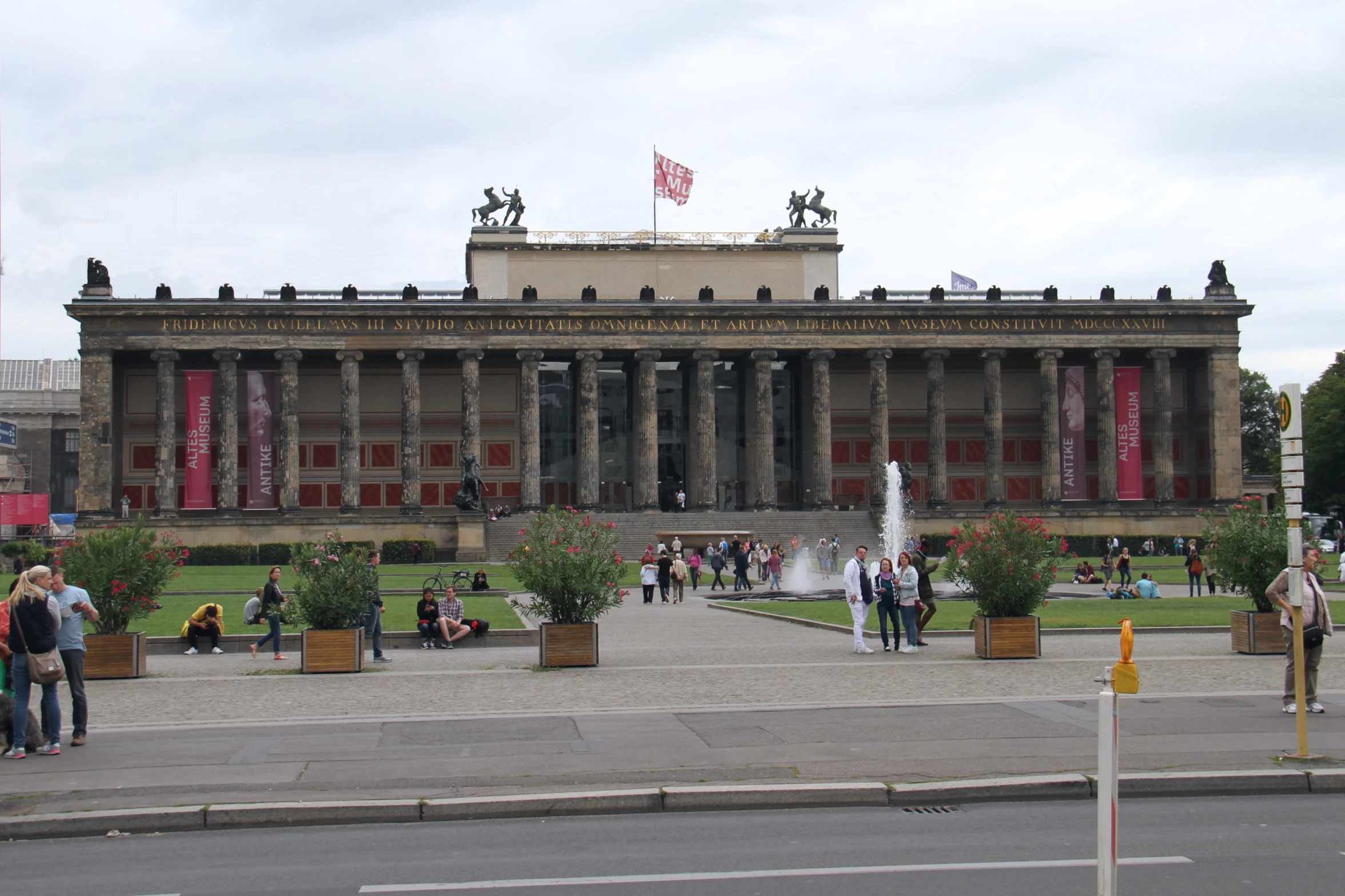 a large stone building that has a fountain in front