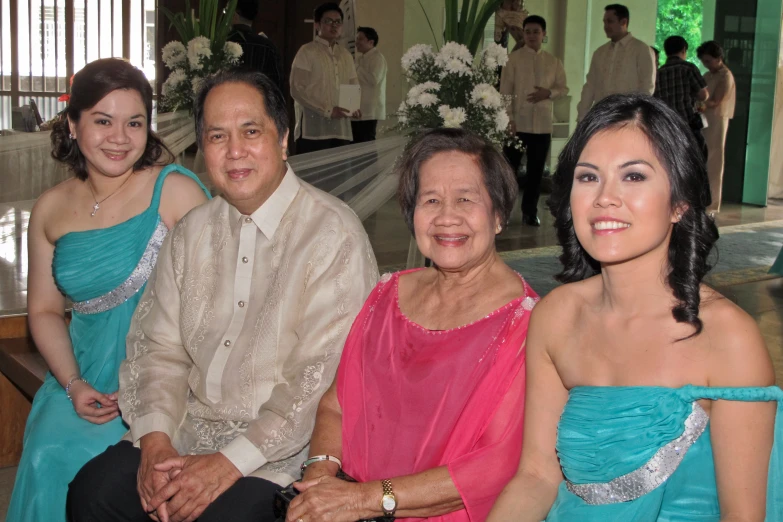 four adults and one child dressed in blue outfits at a party