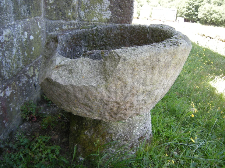 there is a stone sink near the ruins