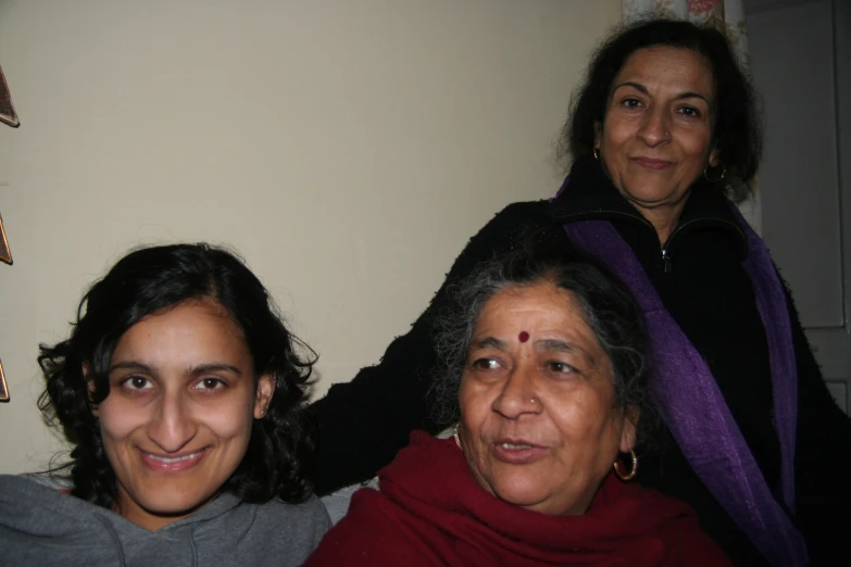 two women and a little girl smile together