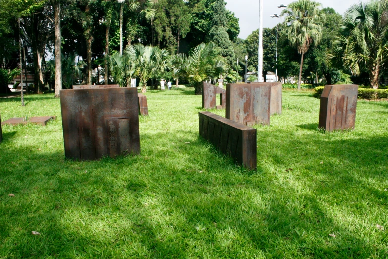 there are three sculpture pieces on the grass