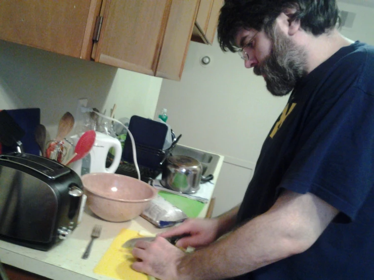 a man in a blue shirt prepares some food