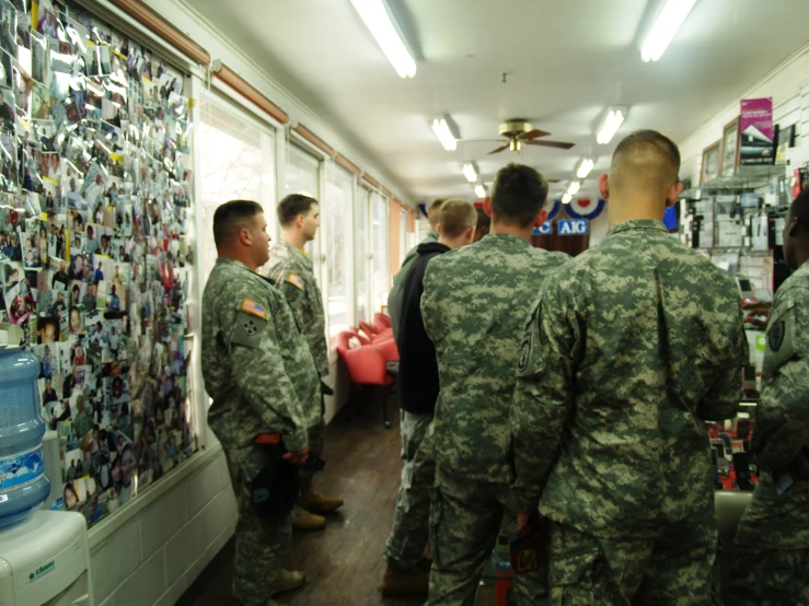 the soldiers are talking at a meeting in the office