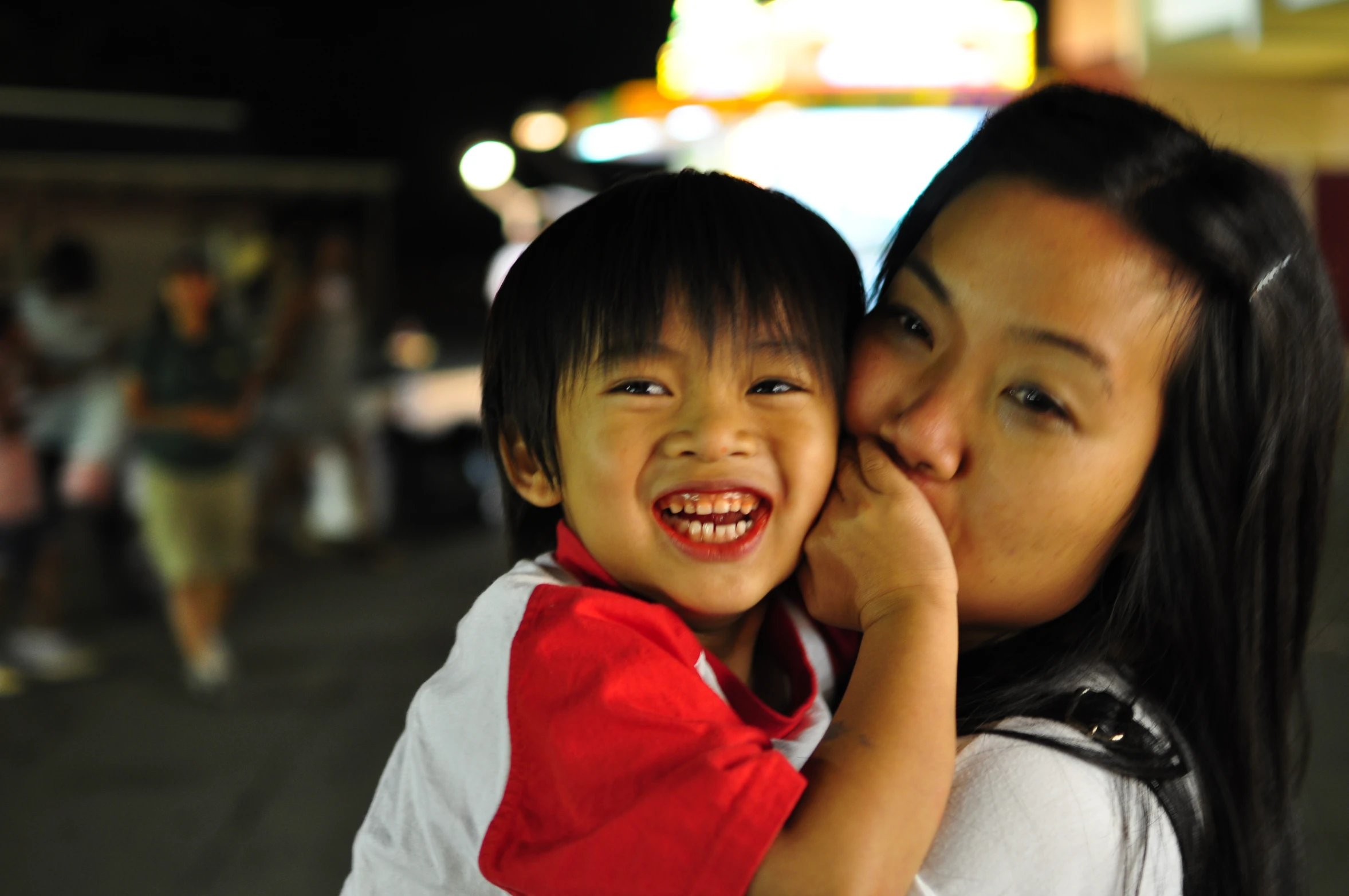 a little boy hugging his mother for the camera